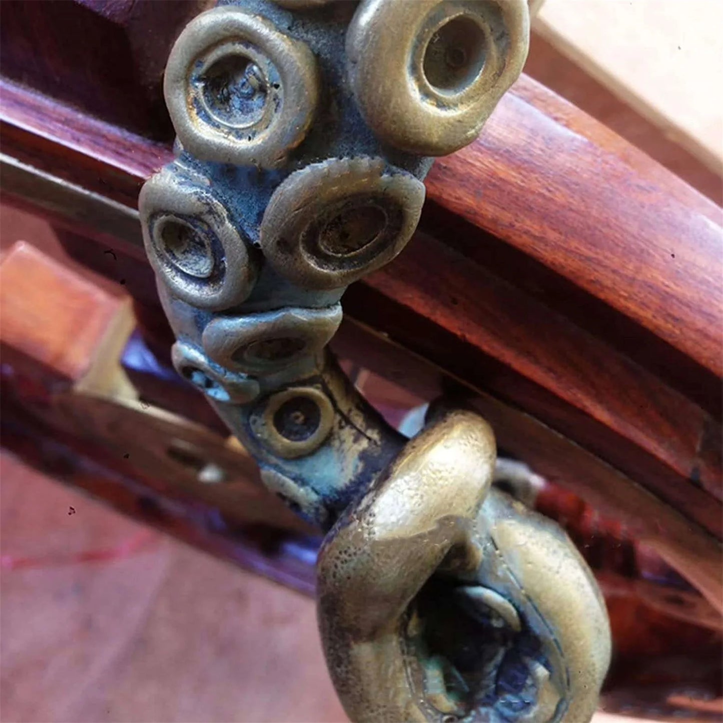 Close up of retro octopus door knob handle with curled tentacles and textured resin surface.
