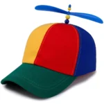 Rainbow propeller hat with a spinning helicopter propeller and rainbow windmill patchwork, worn by a kid at the beach